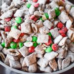 Your family will love this kid-friendly Christmas dessert recipe for Reindeer Treats! It doesn't matter whether you call it Reindeer Treats, Reindeer Chow, Christmas Muddy Buddies, or even Puppy Chow... everyone loves a big bowl of this stuff! This holiday version is even more festive with the addition of red and green candies.