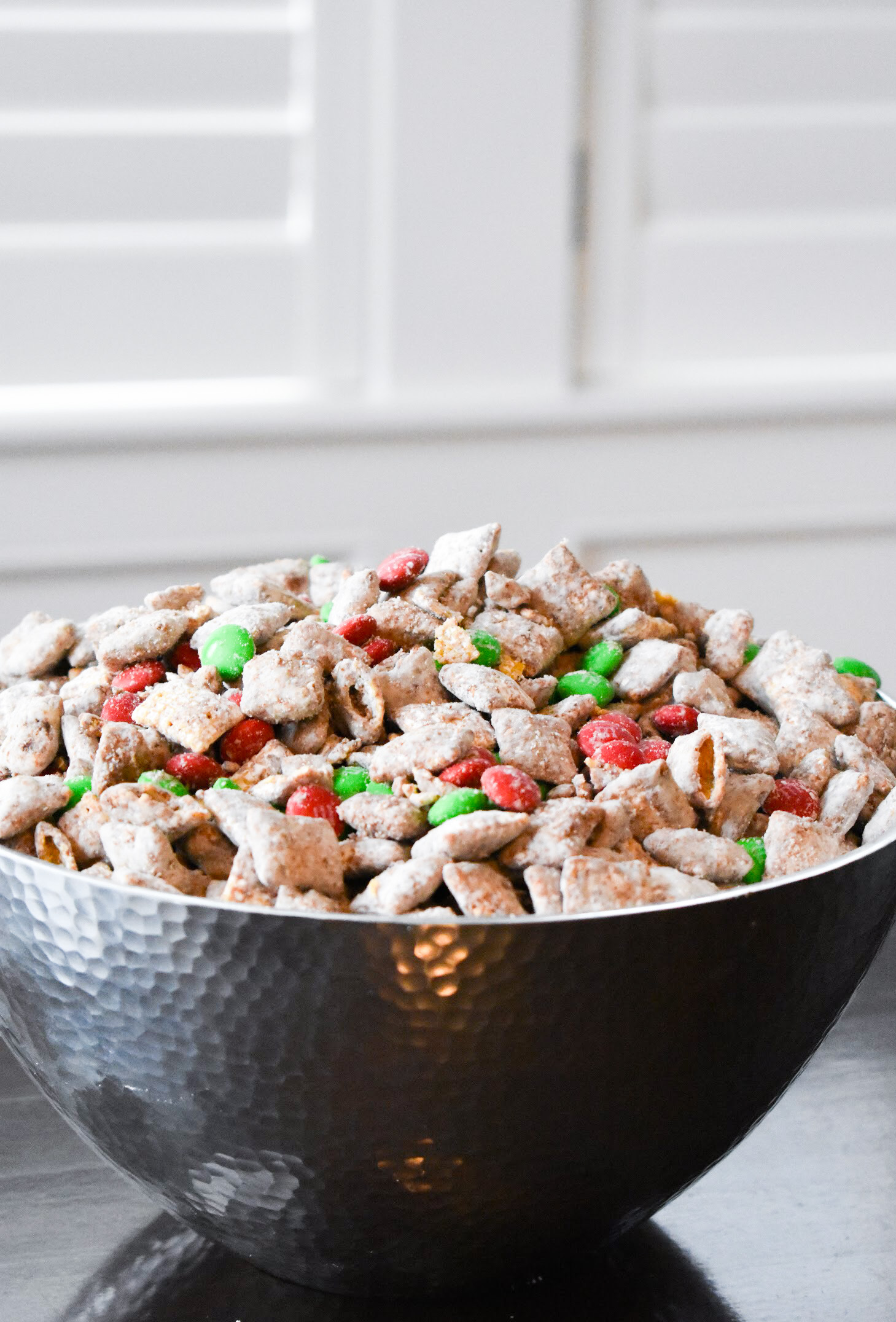 Your family will love this kid-friendly Christmas dessert recipe for Reindeer Treats! It doesn't matter whether you call it Reindeer Treats, Reindeer Chow, Christmas Muddy Buddies, or even Puppy Chow... everyone loves a big bowl of this stuff! This holiday version is even more festive with the addition of red and green candies.