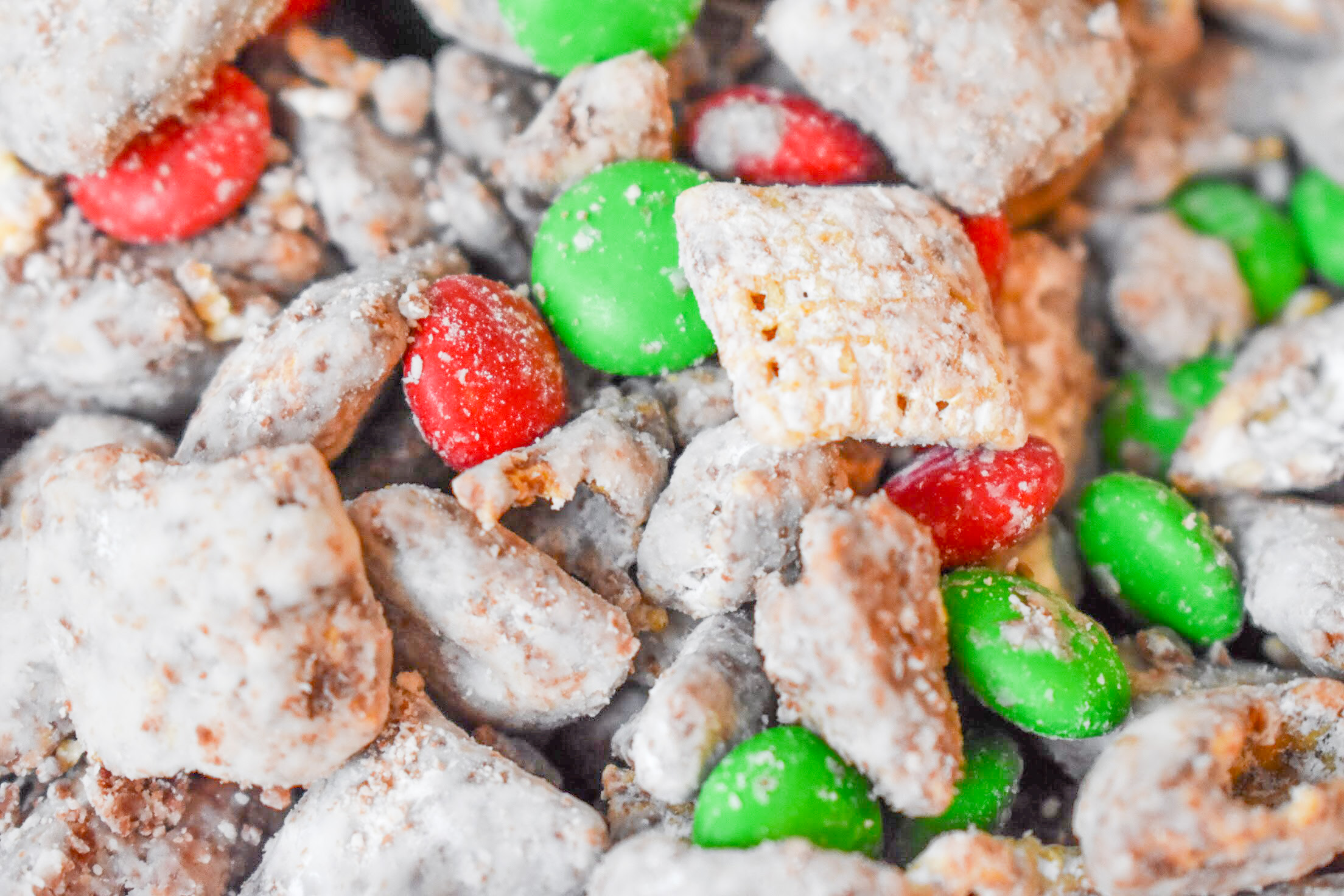 Your family will love this kid-friendly Christmas dessert recipe for Reindeer Treats! It doesn't matter whether you call it Reindeer Treats, Reindeer Chow, Christmas Muddy Buddies, or even Puppy Chow... everyone loves a big bowl of this stuff! This holiday version is even more festive with the addition of red and green candies.