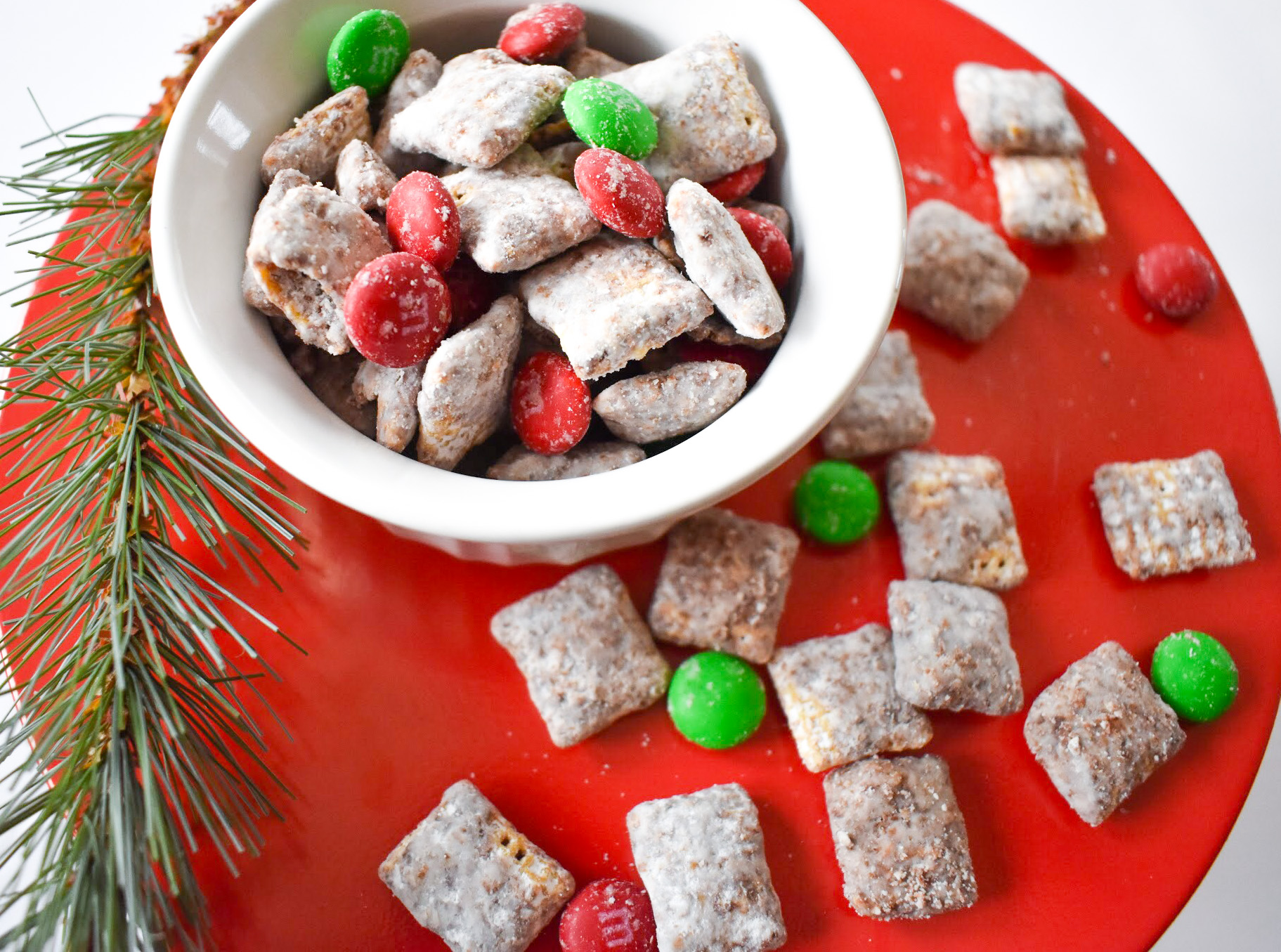 Your family will love this kid-friendly Christmas dessert recipe for Reindeer Treats! It doesn't matter whether you call it Reindeer Treats, Reindeer Chow, Christmas Muddy Buddies, or even Puppy Chow... everyone loves a big bowl of this stuff! This holiday version is even more festive with the addition of red and green candies.