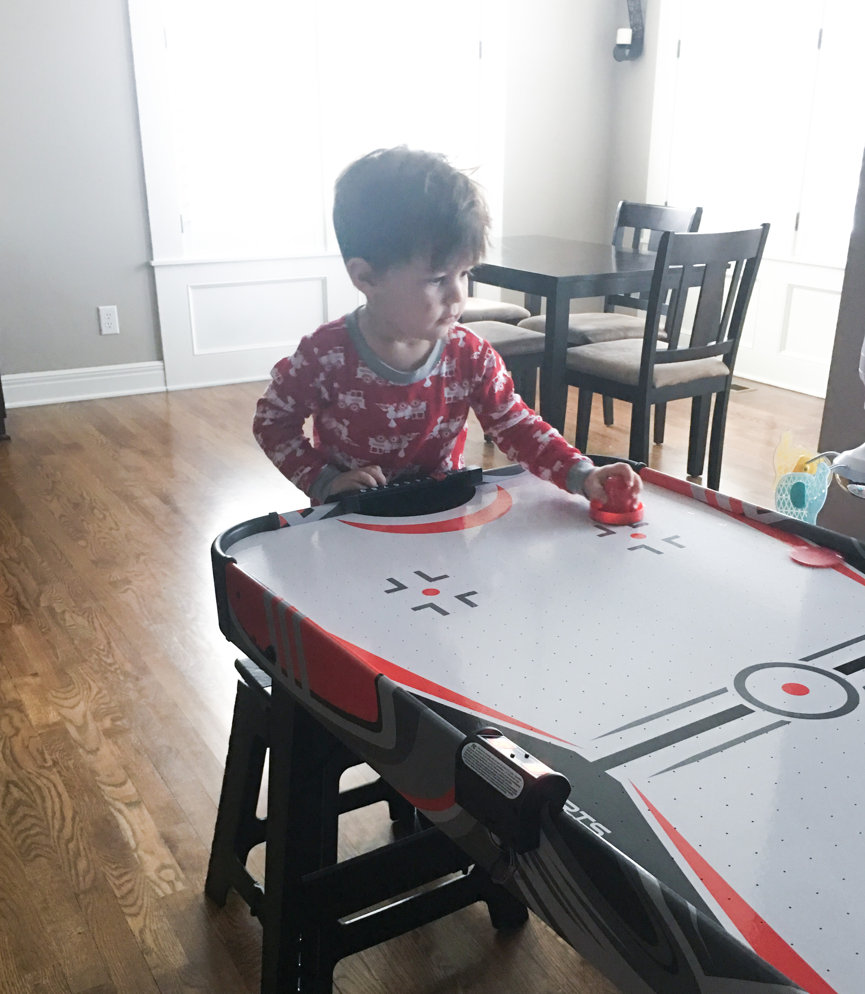 Toddler Boy Playing Air Hockey