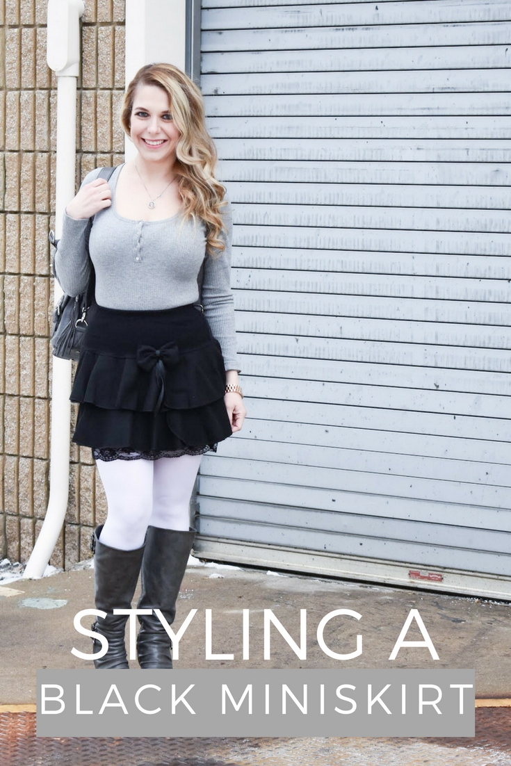 Fashion blogger COVET by tricia styles a ruffled black mini skirt with white tights, a grey bodysuit, grey wedge boots ,and a gorgeous Lily Jade diaper bag. This black mini skirt with ruffles is an affordable statement piece for your wardrobe. Check out this cute winter date night look from Kansas City fashion blogger COVET by tricia.