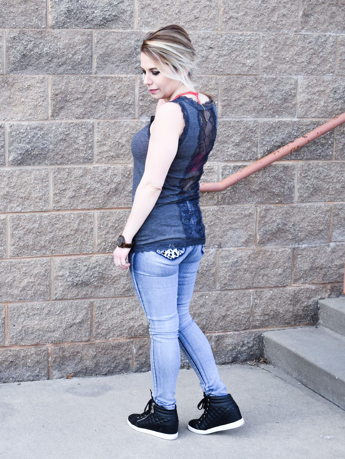 What to Wear Under a Lace Back Top: Lace back tops, open back tops, and sheer blouses present unique wardrobe challenges. Here's how fashion blogger COVET by tricia styled a lace back tank top with skinny jeans and wedge sneakers for a fun warm weather look! Sometimes, the best way to work the lace back is to simply embrace the exposed bra look with a fun bra or bralette!