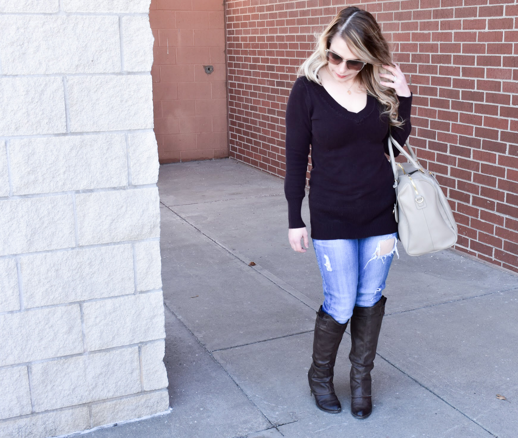 Brown Sweater and Ripped Denim: We're in the midst of a never-ending winter in Kansas City [ugh, Kansas weather!], so, as a Kansas City fashion blogger, I'm sharing one of my favorite winter fashion looks to get your wardrobe through until spring hits! You can't go wrong with a classic brown v-neck sweater, and the ripped jeans give this outfit a bit of edge. Of course, no mom outfit is complete without a stylish diaper bag!