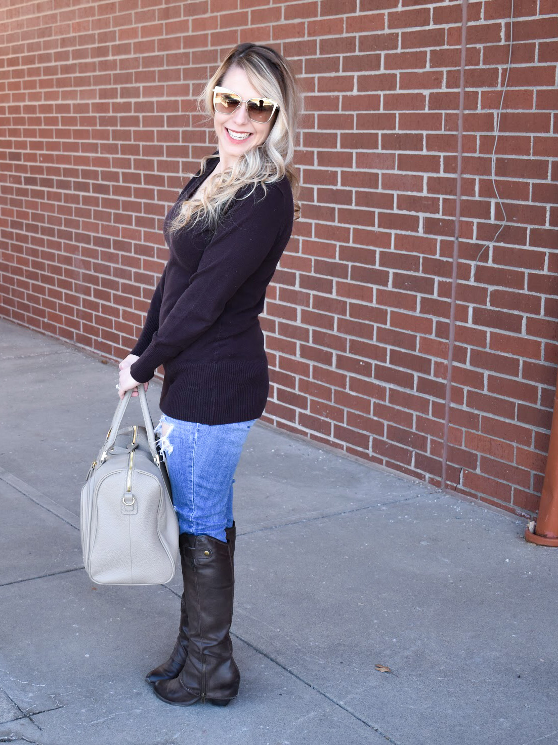 Brown Sweater and Ripped Denim: We're in the midst of a never-ending winter in Kansas City [ugh, Kansas weather!], so, as a Kansas City fashion blogger, I'm sharing one of my favorite winter fashion looks to get your wardrobe through until spring hits! You can't go wrong with a classic brown v-neck sweater, and the ripped jeans give this outfit a bit of edge. Of course, no mom outfit is complete without a stylish diaper bag!