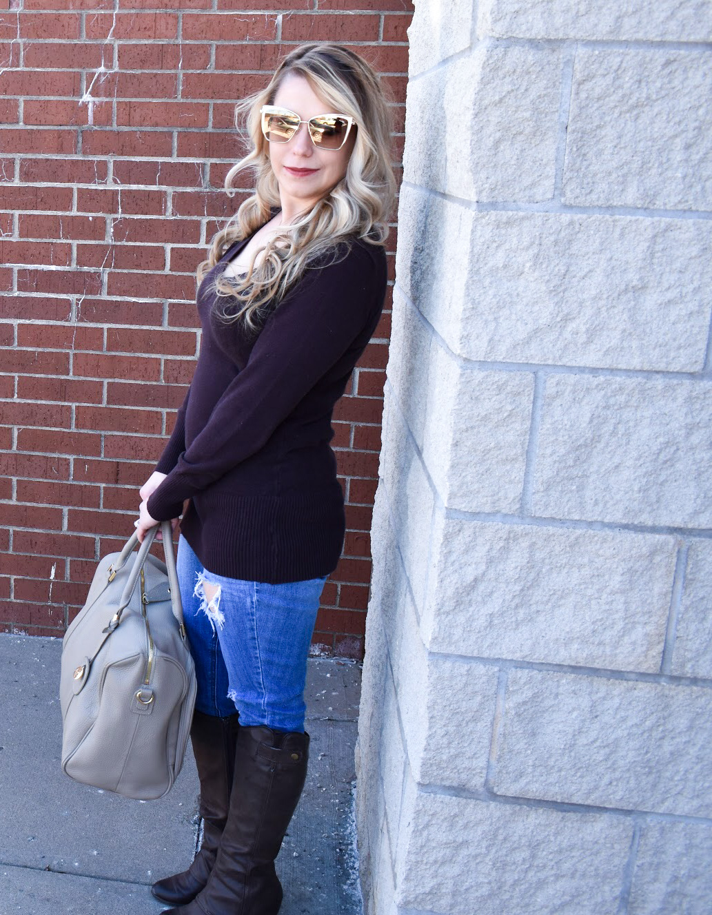 Brown Sweater and Ripped Denim: We're in the midst of a never-ending winter in Kansas City [ugh, Kansas weather!], so, as a Kansas City fashion blogger, I'm sharing one of my favorite winter fashion looks to get your wardrobe through until spring hits! You can't go wrong with a classic brown v-neck sweater, and the ripped jeans give this outfit a bit of edge. Of course, no mom outfit is complete without a stylish diaper bag!