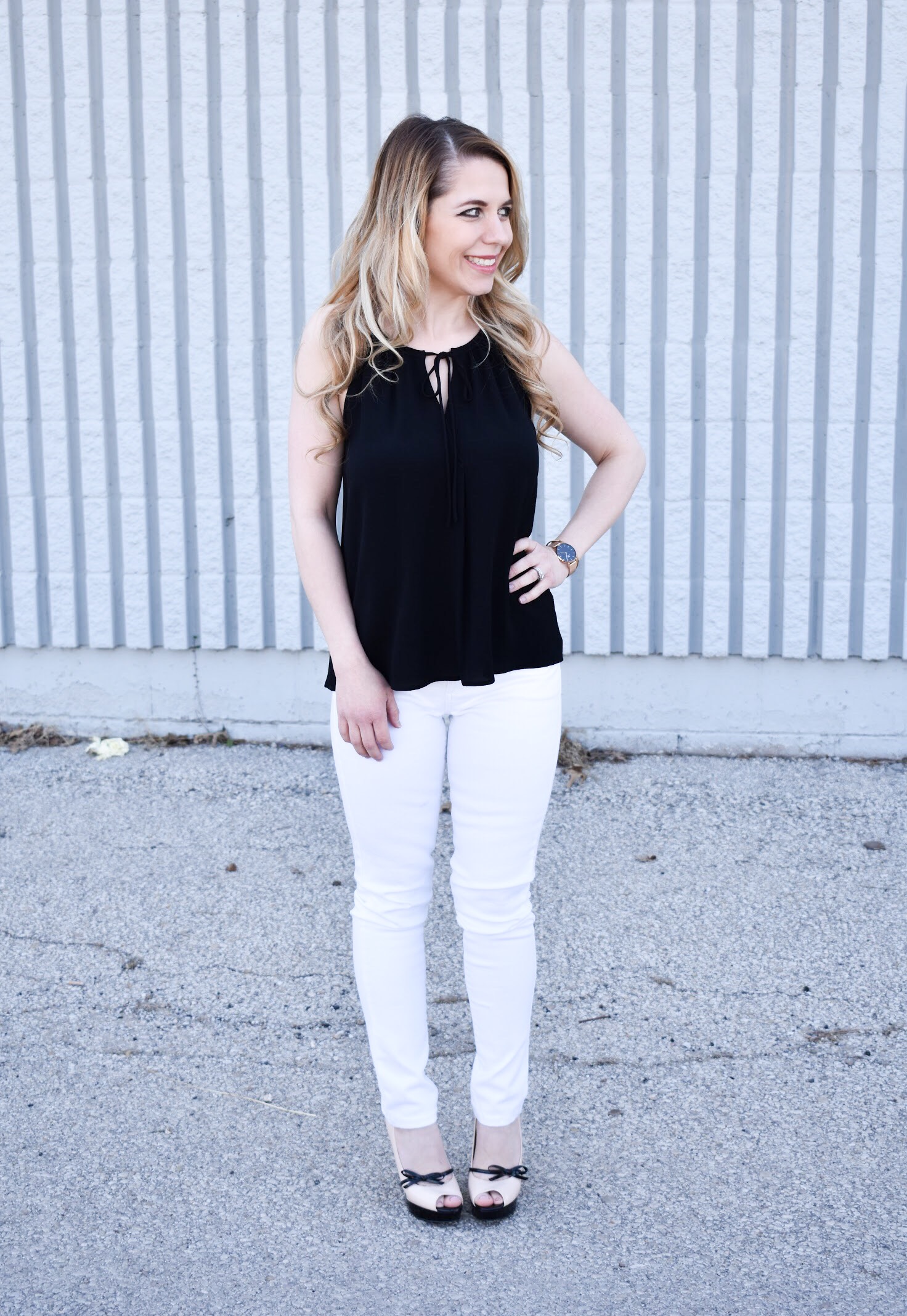 Monochrome Looks for Spring: Some people think you can't wear black and white in the spring. Those people are wrong. Fashion blogger COVET by tricia showcases a springtime monochrome look featuring Banana Republic Stay White Denim and a Tyche black halter top. Minimalist jewelry completes the look. Monochrome is trending for spring 2018, so here's how to effortlessly incorporate it into your wardrobe.