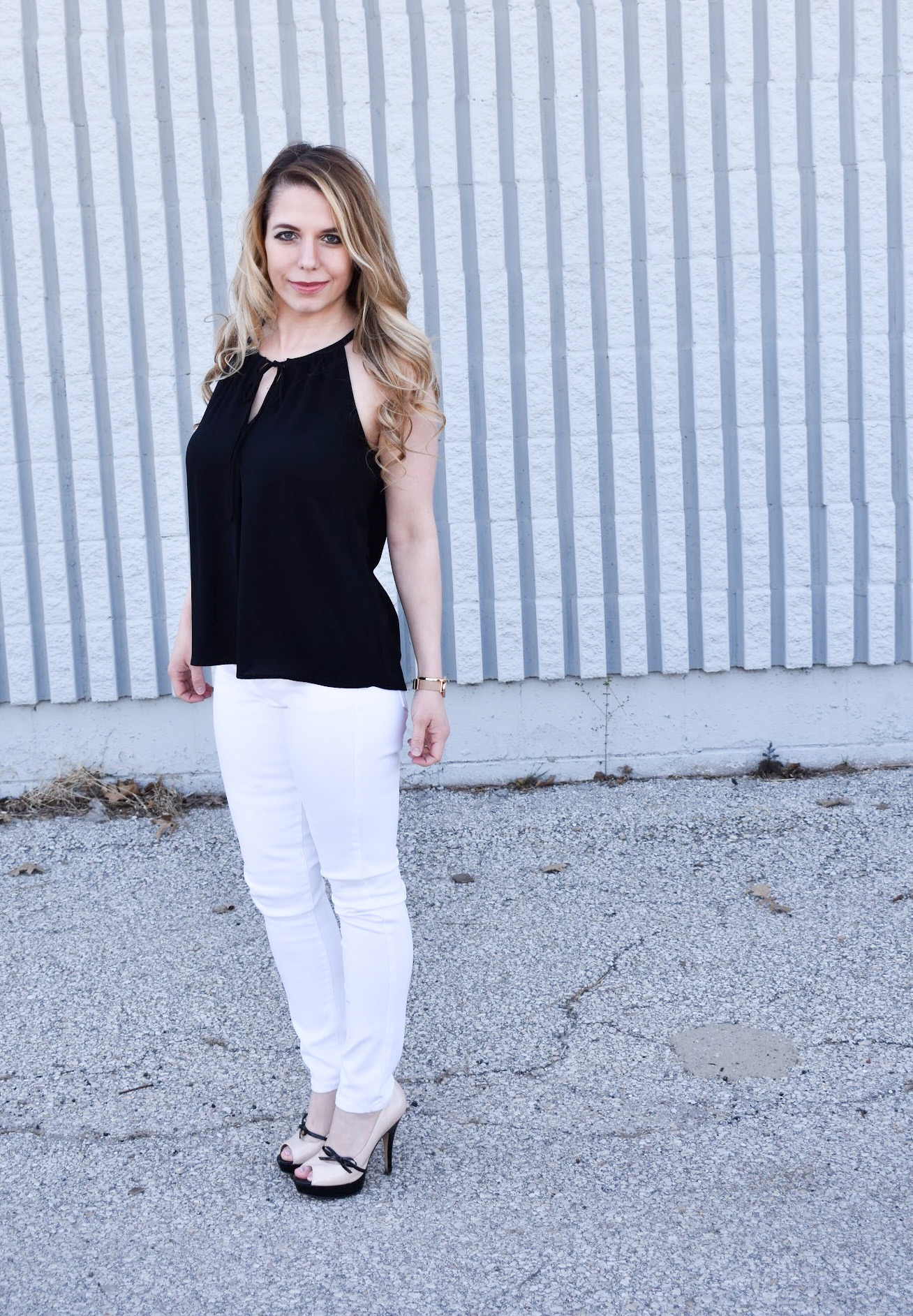 Monochrome Looks for Spring: Some people think you can't wear black and white in the spring. Those people are wrong. Fashion blogger COVET by tricia showcases a springtime monochrome look featuring Banana Republic Stay White Denim and a Tyche black halter top. Minimalist jewelry completes the look. Monochrome is trending for spring 2018, so here's how to effortlessly incorporate it into your wardrobe.