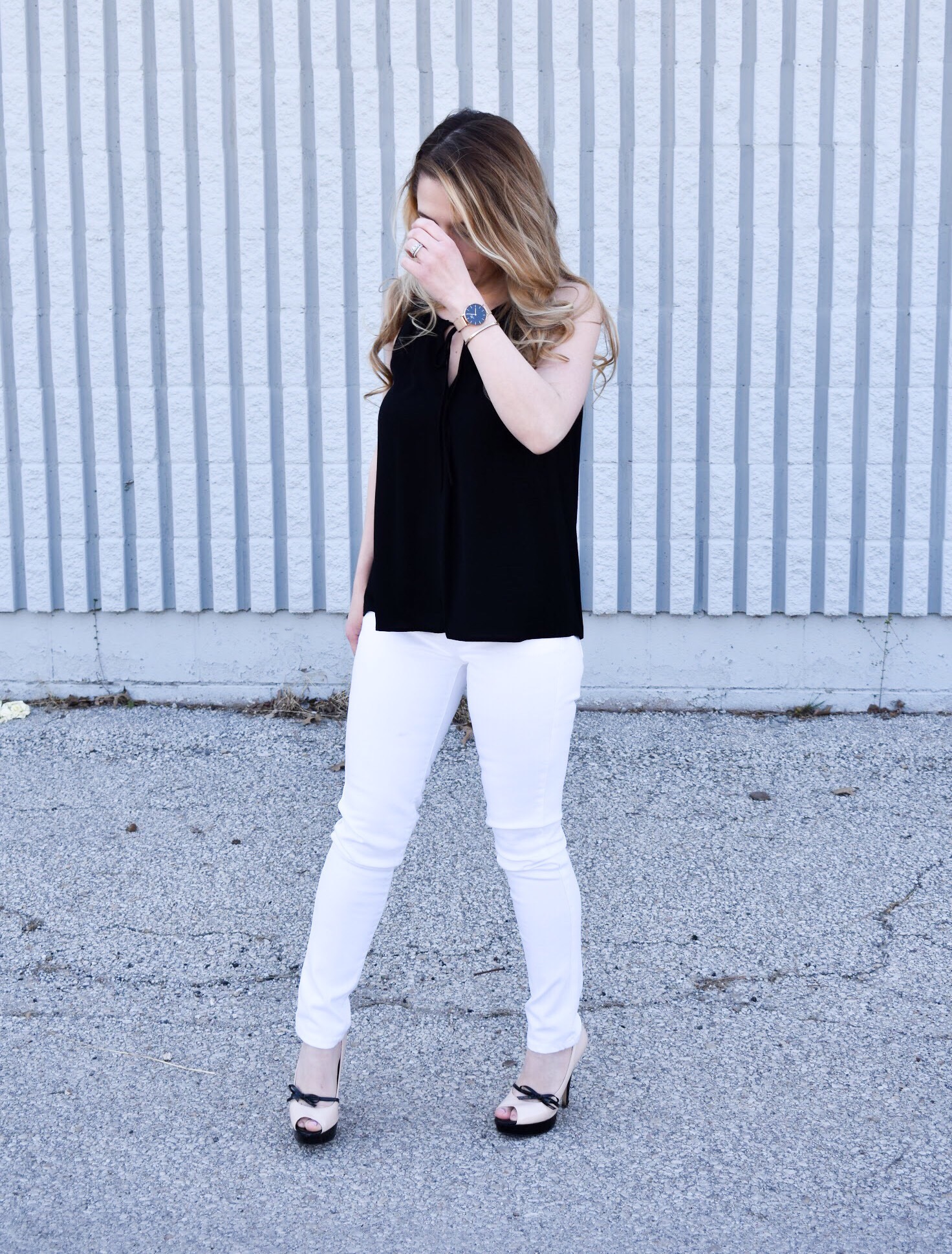 Monochrome Looks for Spring: Some people think you can't wear black and white in the spring. Those people are wrong. Fashion blogger COVET by tricia showcases a springtime monochrome look featuring Banana Republic Stay White Denim and a Tyche black halter top. Minimalist jewelry completes the look. Monochrome is trending for spring 2018, so here's how to effortlessly incorporate it into your wardrobe.