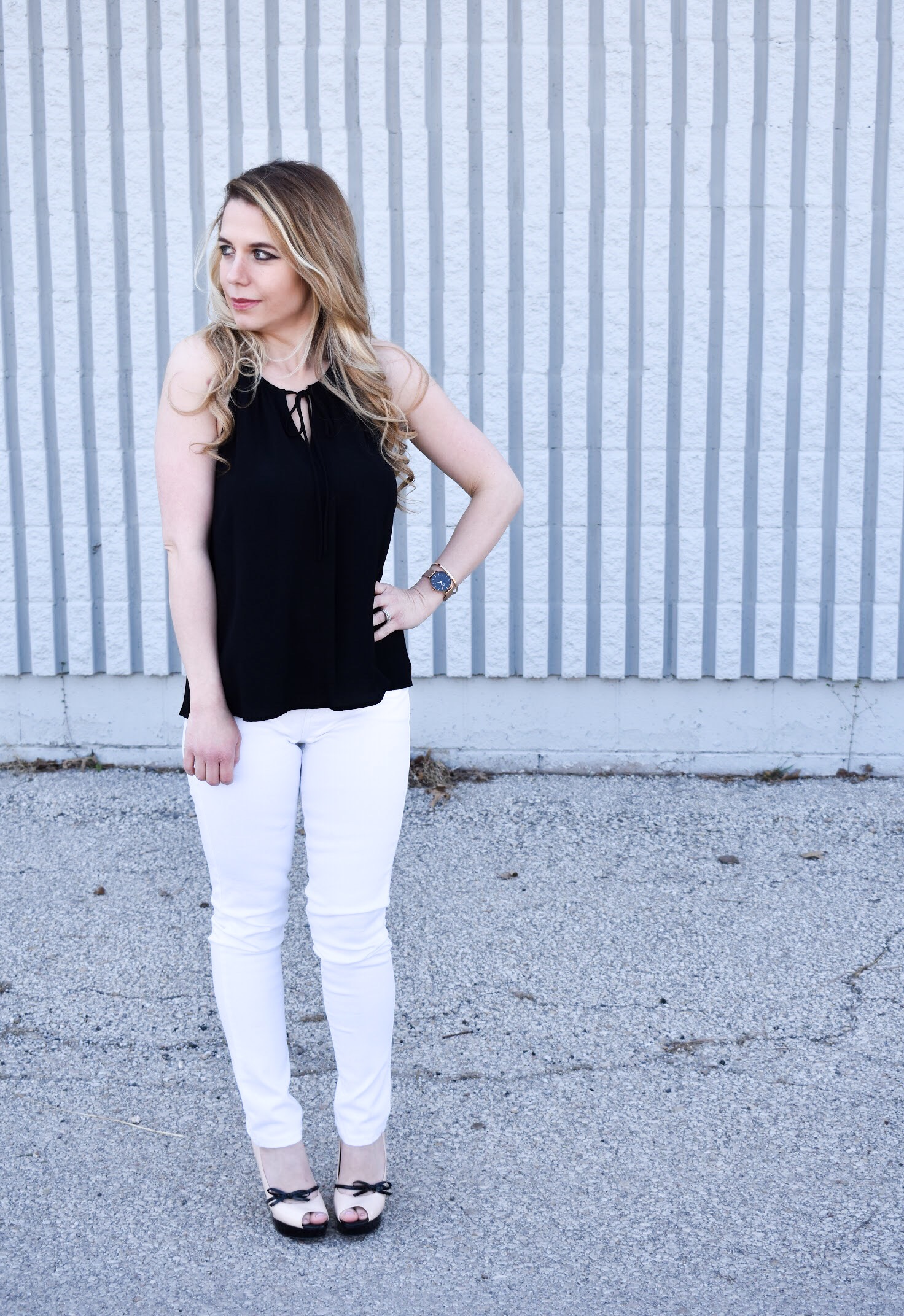 Monochrome Looks for Spring: Some people think you can't wear black and white in the spring. Those people are wrong. Fashion blogger COVET by tricia showcases a springtime monochrome look featuring Banana Republic Stay White Denim and a Tyche black halter top. Minimalist jewelry completes the look. Monochrome is trending for spring 2018, so here's how to effortlessly incorporate it into your wardrobe.