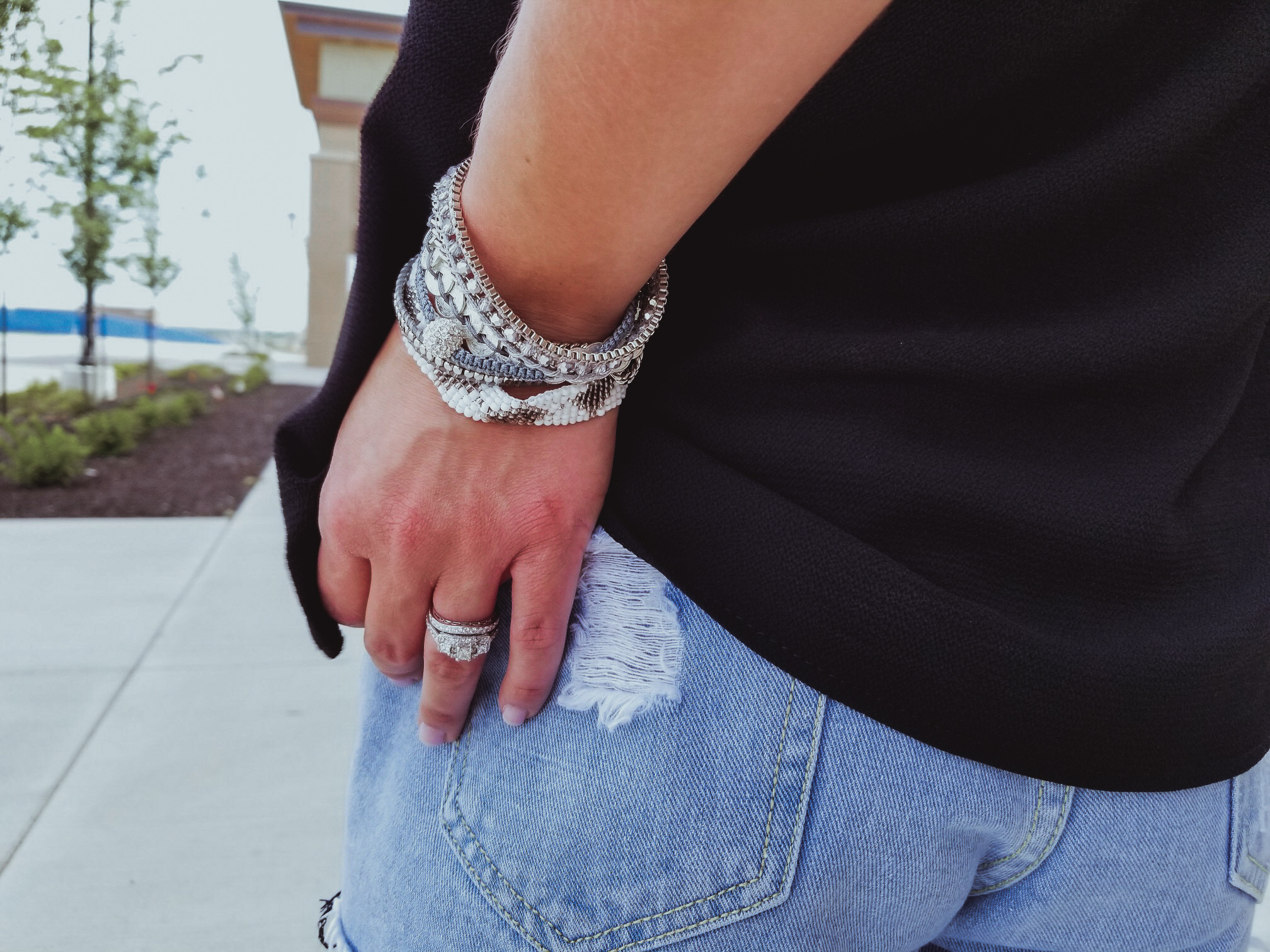 Casual Summer Outfit - Black Halter, Ripped Denim Shorts, and Black Wedges. Summer 2018 is in full swing and here's one of the hottest looks we've seen yet. Pair your ripped jean shorts with a black tank top for a casual summer outfit that's sure to impress. Don't forget the accessories, like the stylish Victoria Emerson bracelet featured here. Click for an exclusive Victoria Emerson coupon code!