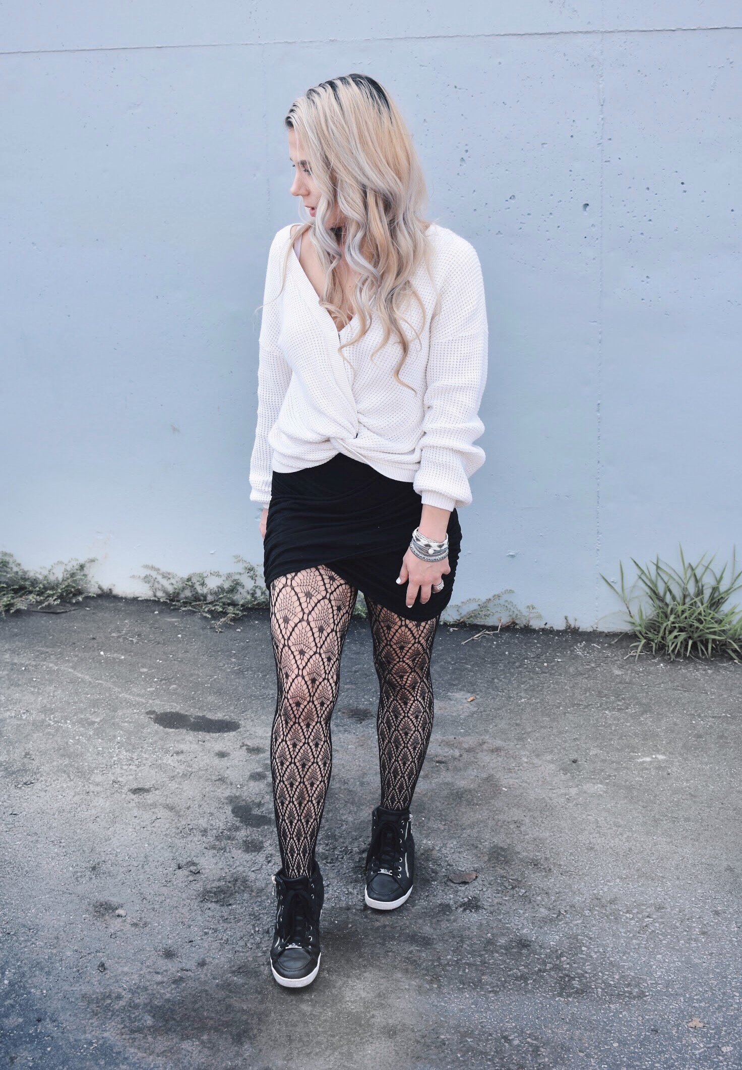 Fishnet Tights Outfit Ideas - Fall Street Style 2018 - Fashion blogger fishnet tights outfit showing how to use fishnet tights to transition your wardrobe to fall. Fishnet tights and mini skirt outfit helps you with how to wear a mini skirt in fall. Plus, this twist-front sweater is the cutest you'll ever see! Check out this Street Style Fall 2018 inspiration! #LikeTKit #Fishnets #FishnetTights #FallFashion #WomensFashion