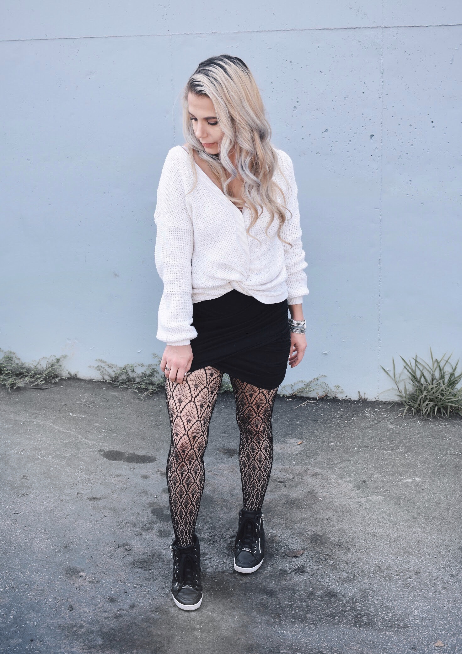 Fishnet Tights Outfit Ideas - Fall Street Style 2018 - Fashion blogger fishnet tights outfit showing how to use fishnet tights to transition your wardrobe to fall. Fishnet tights and mini skirt outfit helps you with how to wear a mini skirt in fall. Plus, this twist-front sweater is the cutest you'll ever see! Check out this Street Style Fall 2018 inspiration! #LikeTKit #Fishnets #FishnetTights #FallFashion #WomensFashion