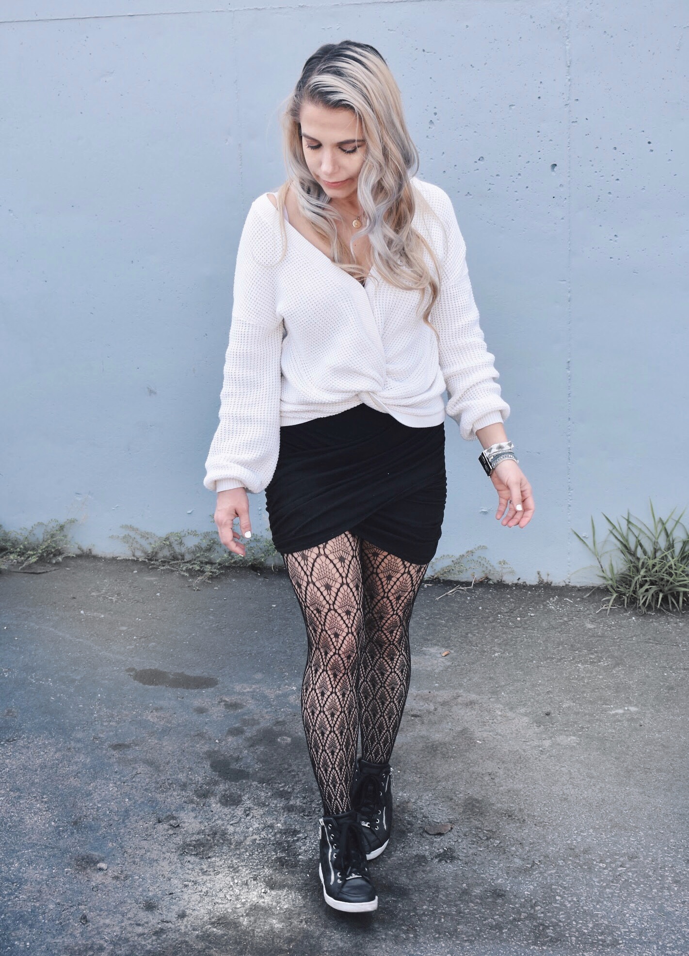 Fishnet Tights Outfit Ideas - Fall Street Style 2018 - Fashion blogger fishnet tights outfit showing how to use fishnet tights to transition your wardrobe to fall. Fishnet tights and mini skirt outfit helps you with how to wear a mini skirt in fall. Plus, this twist-front sweater is the cutest you'll ever see! Check out this Street Style Fall 2018 inspiration! #LikeTKit #Fishnets #FishnetTights #FallFashion #WomensFashion