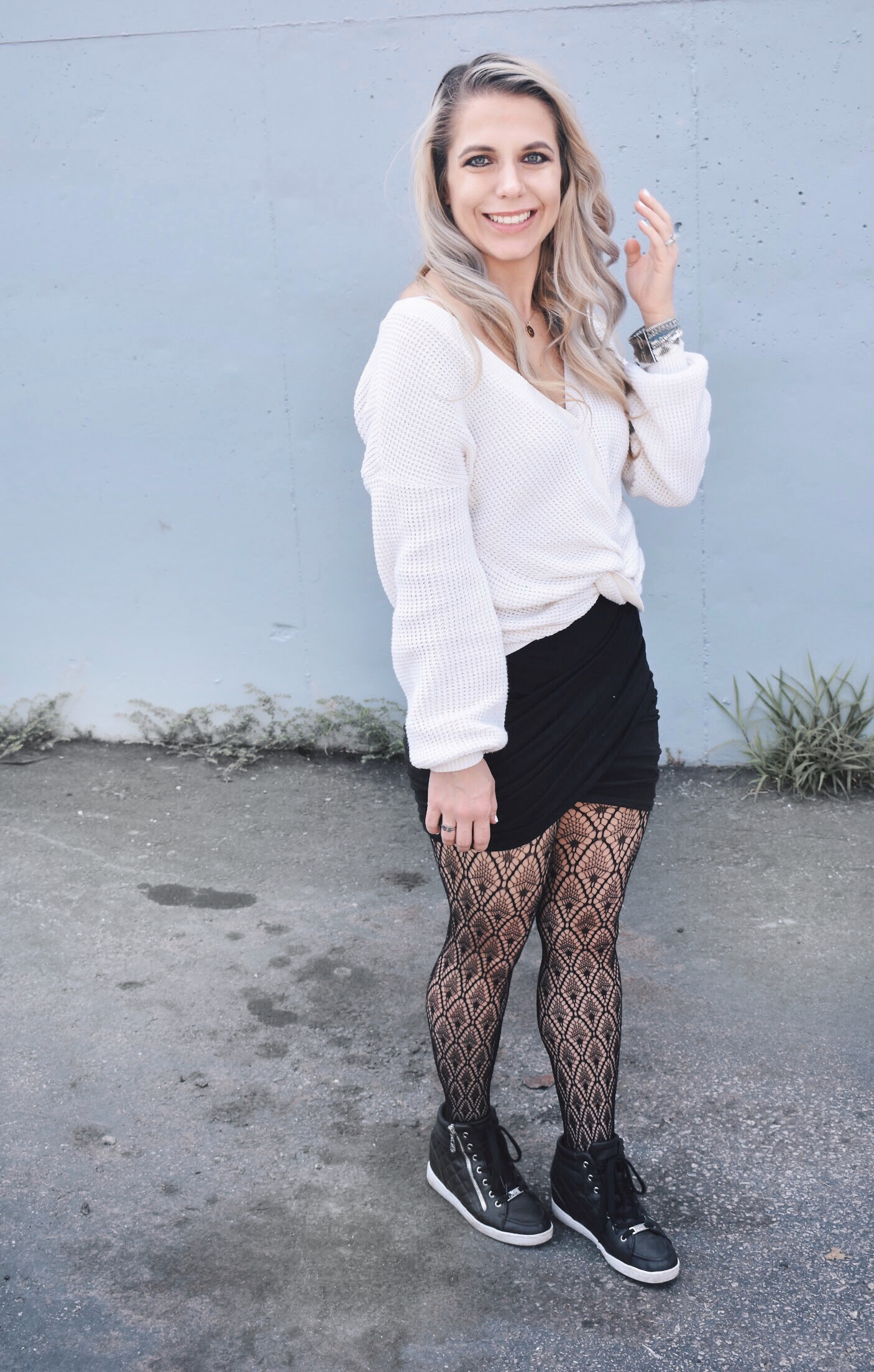 Fishnet Tights Outfit Ideas - Fall Street Style 2018 - Fashion blogger fishnet tights outfit showing how to use fishnet tights to transition your wardrobe to fall. Fishnet tights and mini skirt outfit helps you with how to wear a mini skirt in fall. Plus, this twist-front sweater is the cutest you'll ever see! Check out this Street Style Fall 2018 inspiration! #LikeTKit #Fishnets #FishnetTights #FallFashion #WomensFashion