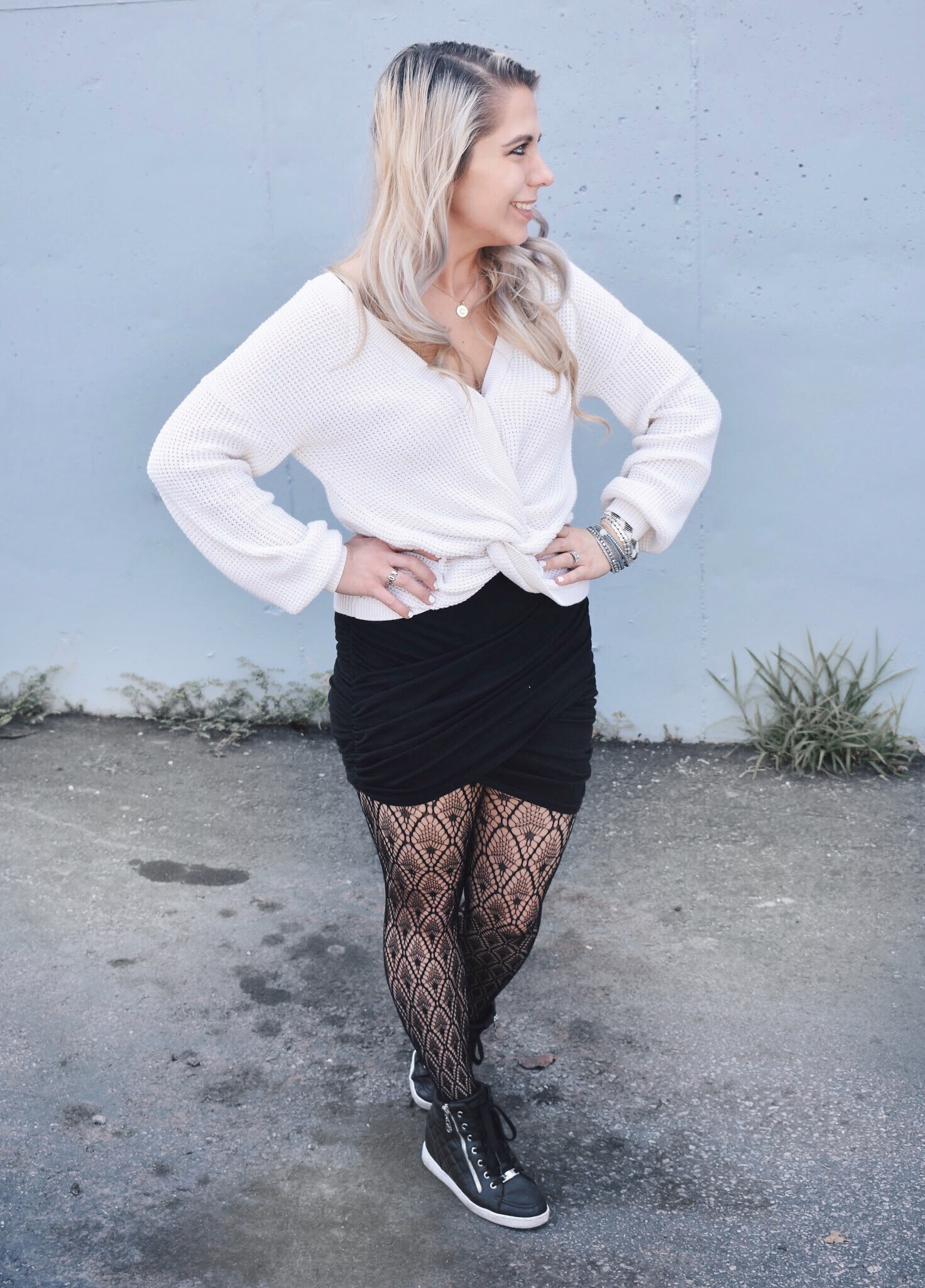 Fishnet Tights Outfit Ideas - Fall Street Style 2018 - Fashion blogger fishnet tights outfit showing how to use fishnet tights to transition your wardrobe to fall. Fishnet tights and mini skirt outfit helps you with how to wear a mini skirt in fall. Plus, this twist-front sweater is the cutest you'll ever see! Check out this Street Style Fall 2018 inspiration! #LikeTKit #Fishnets #FishnetTights #FallFashion #WomensFashion