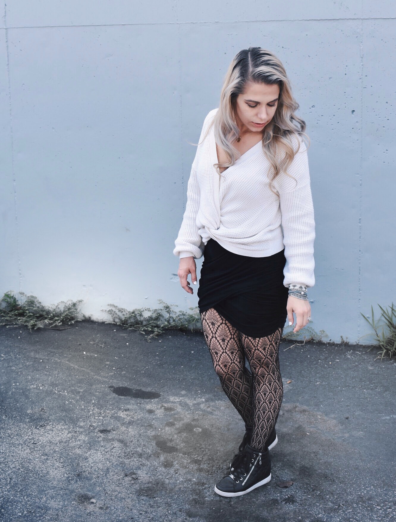 Fishnet Tights Outfit Ideas - Fall Street Style 2018 - Fashion blogger fishnet tights outfit showing how to use fishnet tights to transition your wardrobe to fall. Fishnet tights and mini skirt outfit helps you with how to wear a mini skirt in fall. Plus, this twist-front sweater is the cutest you'll ever see! Check out this Street Style Fall 2018 inspiration! #LikeTKit #Fishnets #FishnetTights #FallFashion #WomensFashion