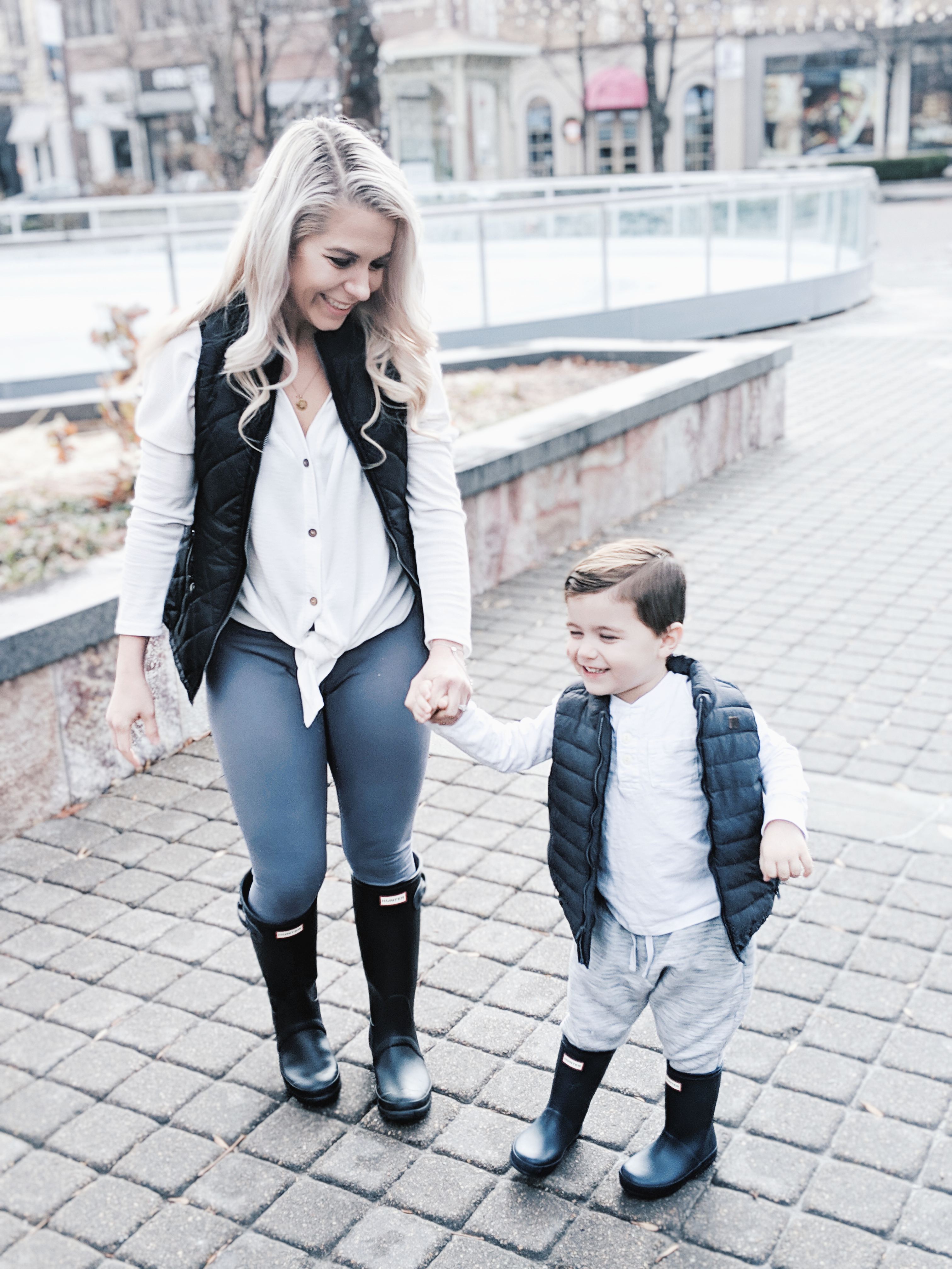Mommy and Me Outfits - Winter Style: Fashion blogger Tricia Nibarger of COVET by tricia showcases twinning looks for the winter! Find the cutest mommy and me fashion for boy moms or girl moms with these matching puffer vests, henleys, and Hunter boots. Casual winter style for moms. #MommyandMe #MomLife #Twinning