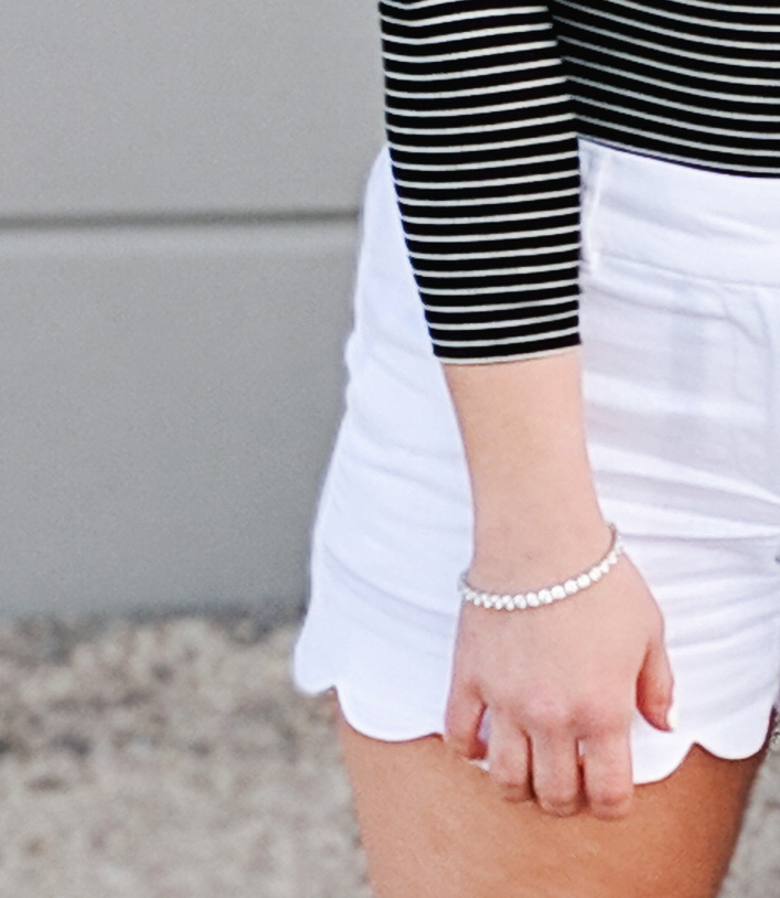 #sponsored This gorgeous tennis bracelet is the perfect finishing touch to this black and white spring outfit! The tennis bracelet is from @Kohls fine jewelry collection and matches everything! I love the sparkle it adds to this black bodysuit and white scalloped shorts outfit for spring fashion 2019. #KohlsJewelry #KohlsFinds #WomensFashion #SpringStyle 