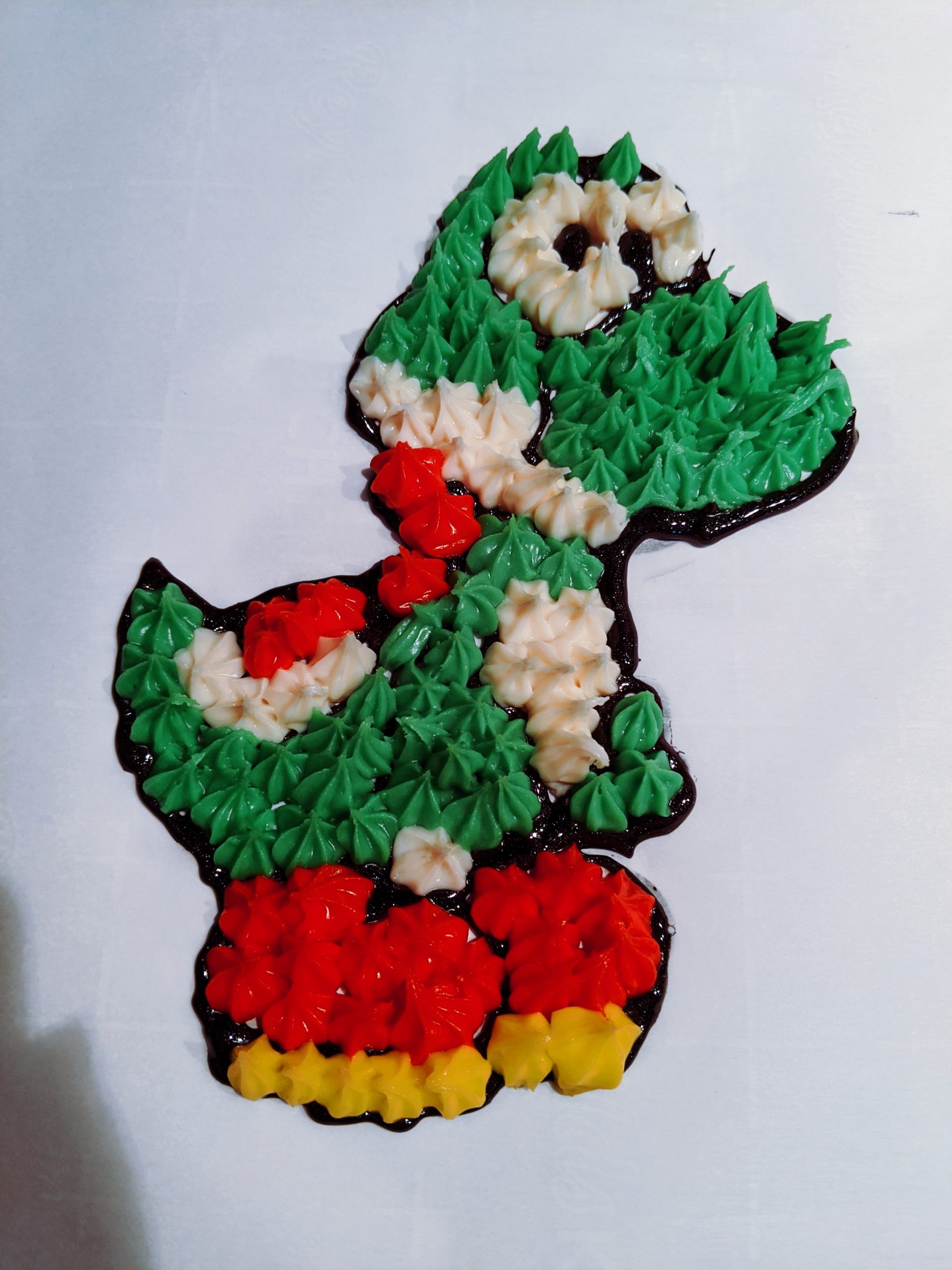 How to Make a Character Cake - DIY Character Cake: Easy DIY Instructions to put ANY character on a cake! Here's how to do a frozen buttercream transfer to make a character cake. #cakedecorating #yoshi #cakes 