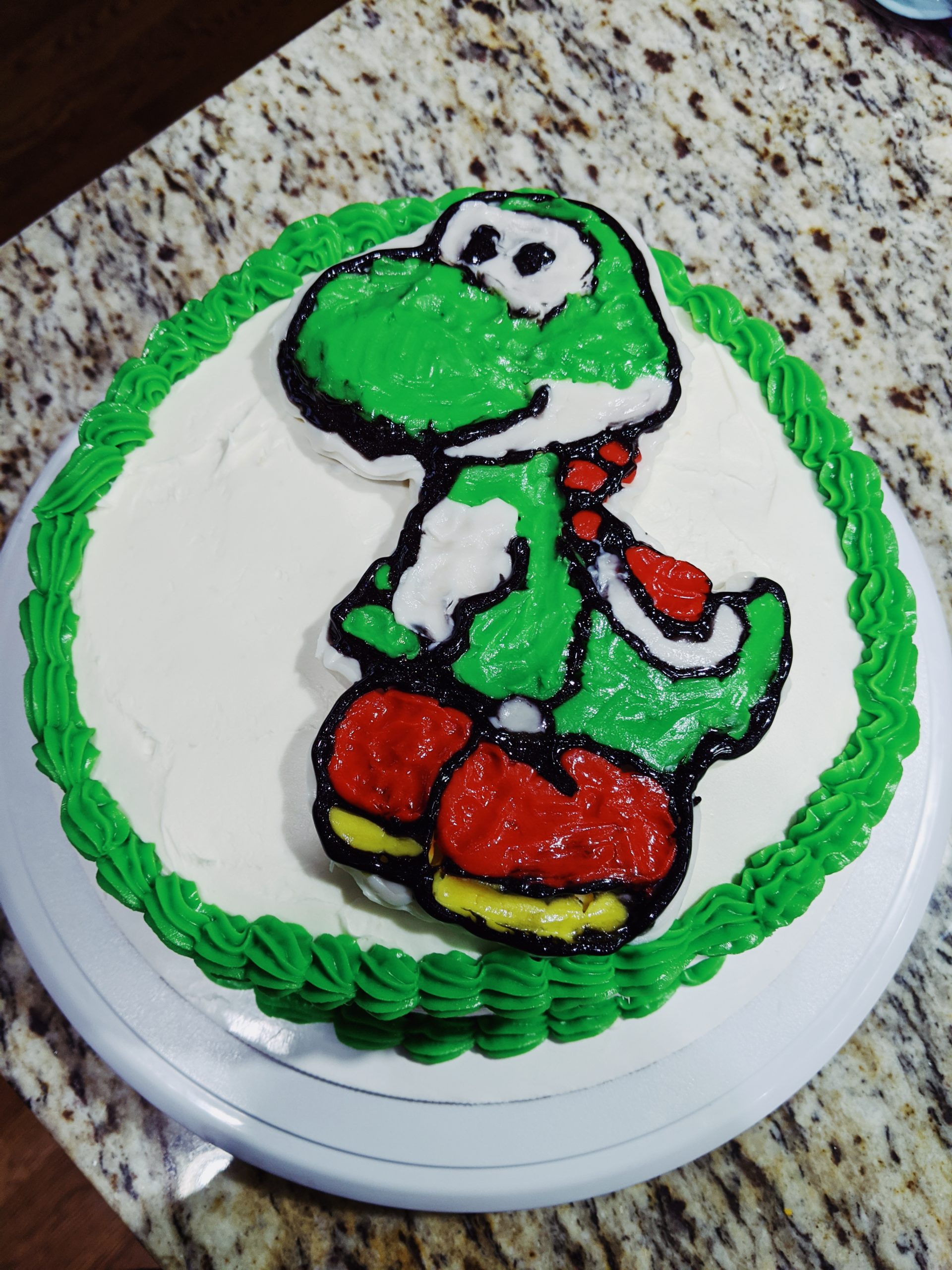 How to Make a Character Cake - DIY Character Cake: Easy DIY Instructions to put ANY character on a cake! Here's how to do a frozen buttercream transfer to make a character cake. #cakedecorating #yoshi #cakes 