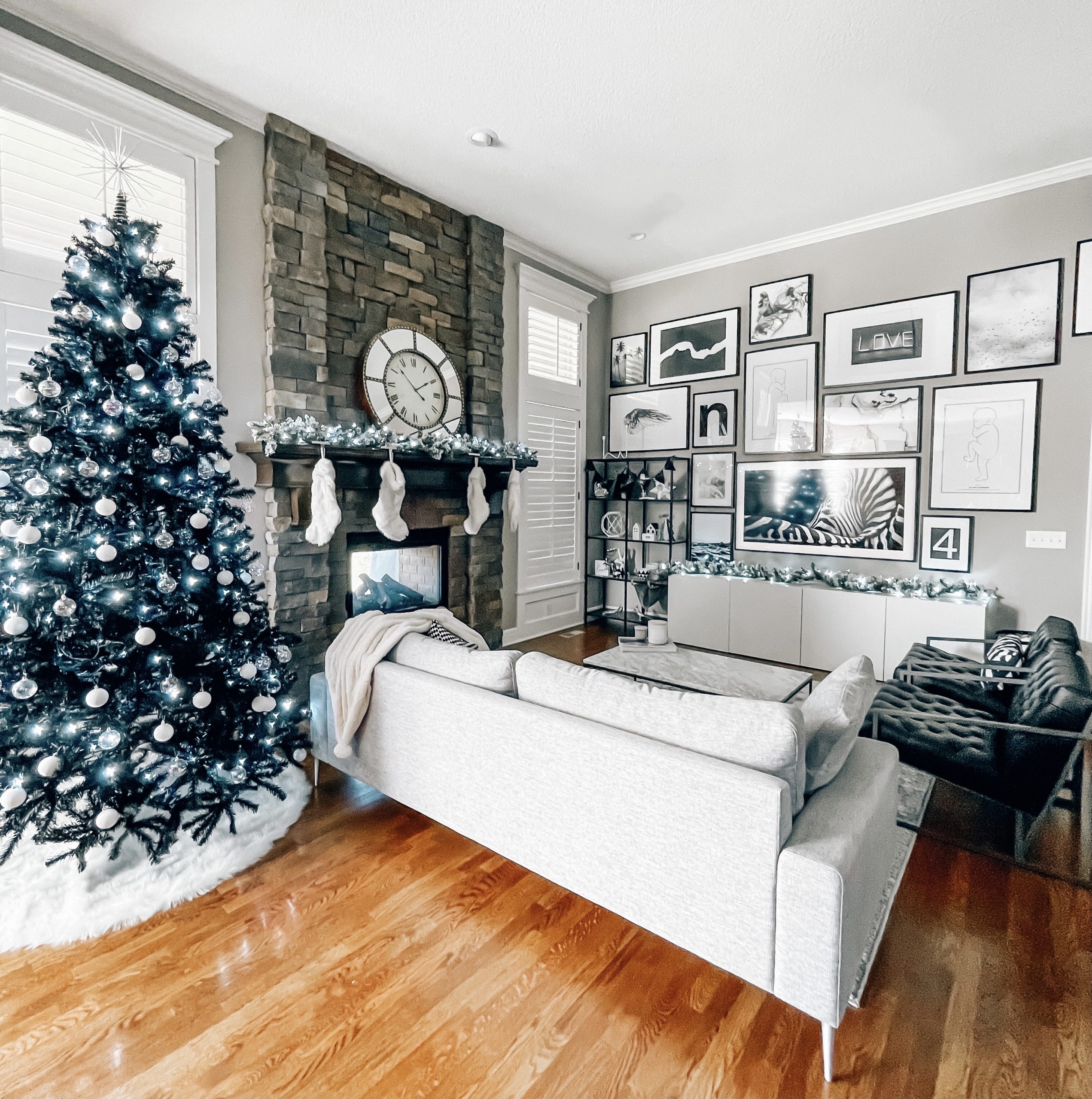 Modern Living Room Christmas Decor - Blogger Tricia Nibarger shares living room Christmas decor in her modern home, featuring a black Christmas tree and a monochrome Christmas theme! #modern #christmasdecor #blackchristmastree 