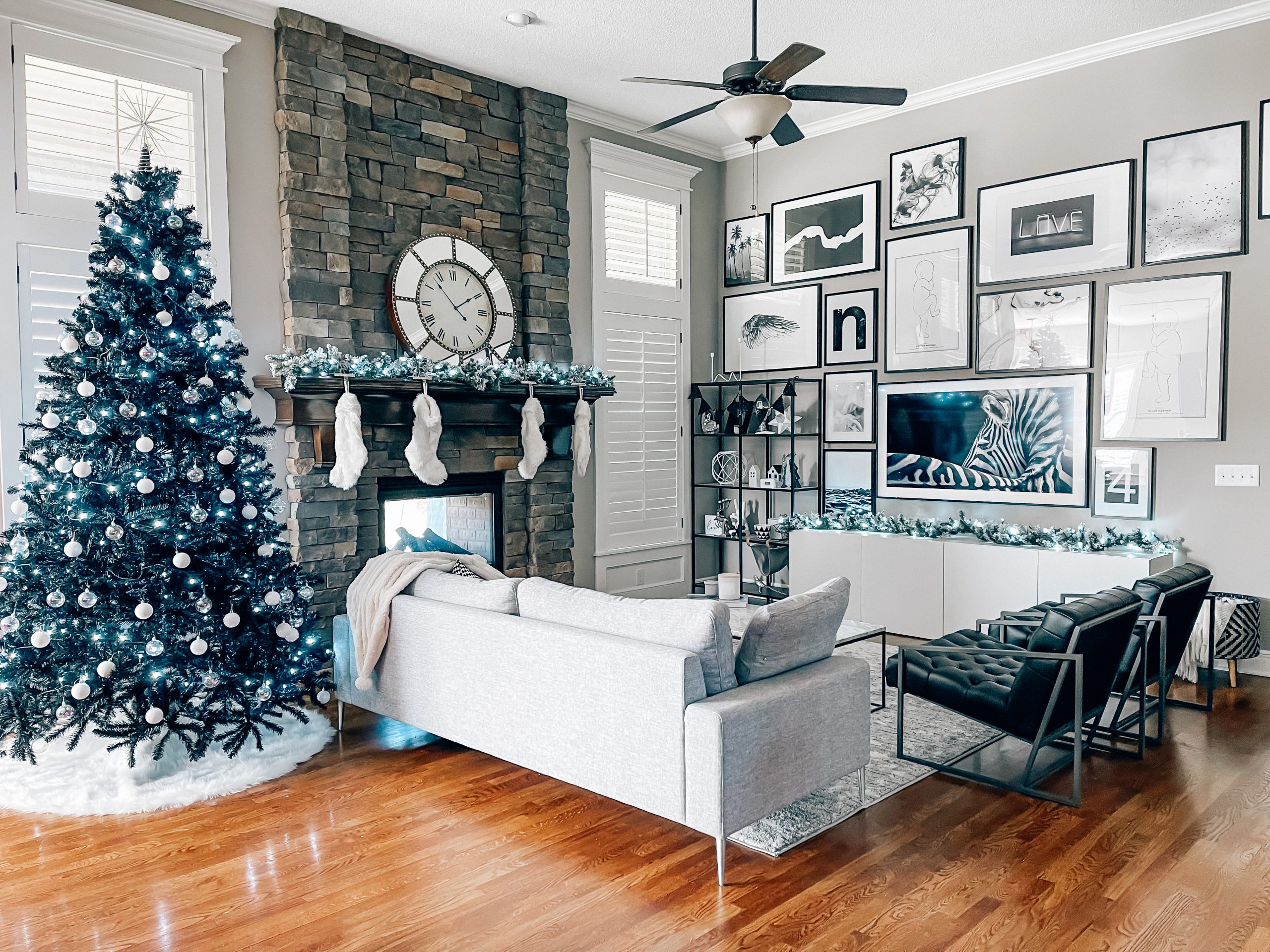 Modern Living Room Christmas Decor - Blogger Tricia Nibarger shares living room Christmas decor in her modern home, featuring a black Christmas tree and a monochrome Christmas theme! #modern #christmasdecor #blackchristmastree 